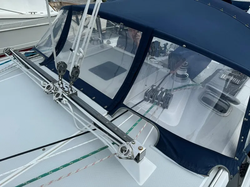 Slide: The Image of 2004 Catalina 42 MkII sailboat with blue canvas cover and rigging details. - 9