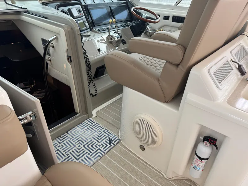 Slide: The Image of 2008 Sea Ray 40 Motor Yacht helm with beige seating and modern controls. - 22