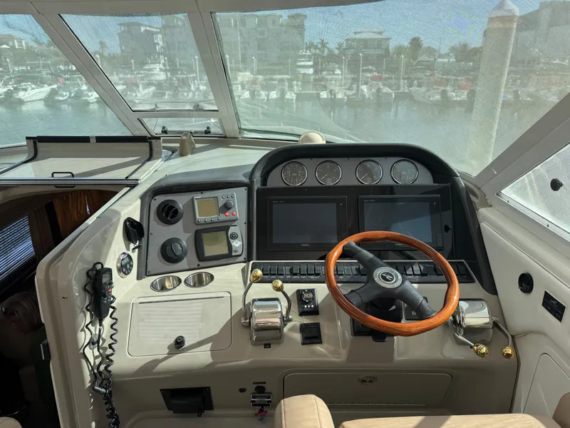 Slide: The Image of 2008 Sea Ray 40 Motor Yacht helm with wood steering wheel and navigation instruments. - 28