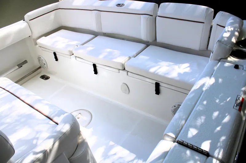 Slide: The Image of 2018 Sea Hunt Ultra 255 SE boat interior with white cushioned seating. - 14