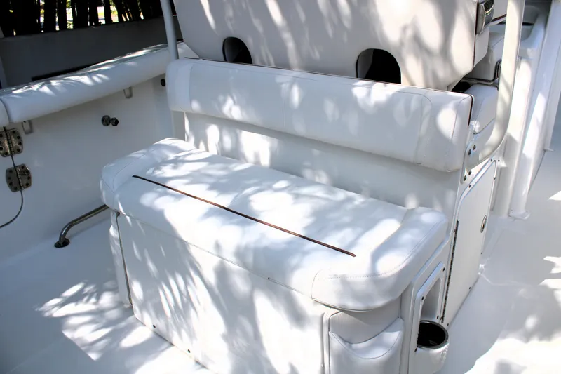 Slide: The Image of 2018 Sea Hunt Ultra 255 SE boat interior with white cushioned seating. - 17