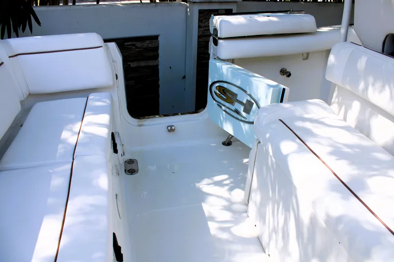 Slide: The Image of 2018 Sea Hunt Ultra 255 SE boat interior with white seating and logo. - 18