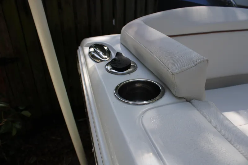 Slide: The Image of 2018 Sea Hunt Ultra 255 SE boat interior with cup holders and seating. - 19