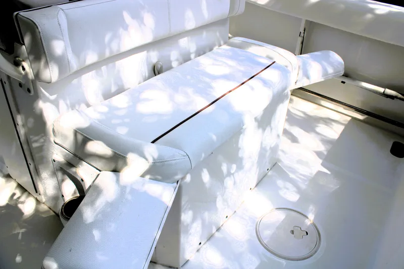 Slide: The Image of 2018 Sea Hunt Ultra 255 SE boat interior with white seating and deck. - 21