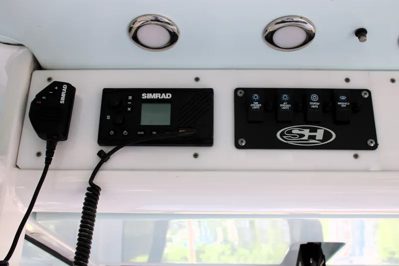 Slide: The Image of 2018 Sea Hunt Ultra 255 SE dashboard with Simrad electronics and control panel. - 25
