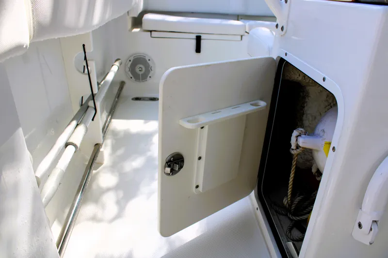 Slide: The Image of 2018 Sea Hunt Ultra 255 SE boat interior storage compartment with open door. - 26