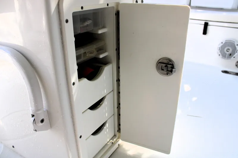 Slide: The Image of Open storage compartment on 2018 Sea Hunt Ultra 255 SE boat. - 27
