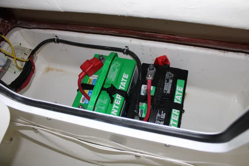 Slide: The Image of 2018 Sea Hunt Ultra 255 SE boat battery compartment with Interstate batteries. - 31