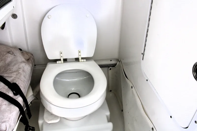 Slide: The Image of 2018 Sea Hunt Ultra 255 SE boat toilet interior. - 32