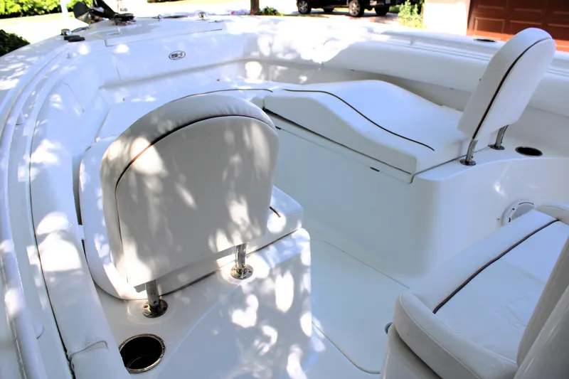 Slide: The Image of 2018 Sea Hunt Ultra 255 SE boat interior with white seating and sleek design. - 34