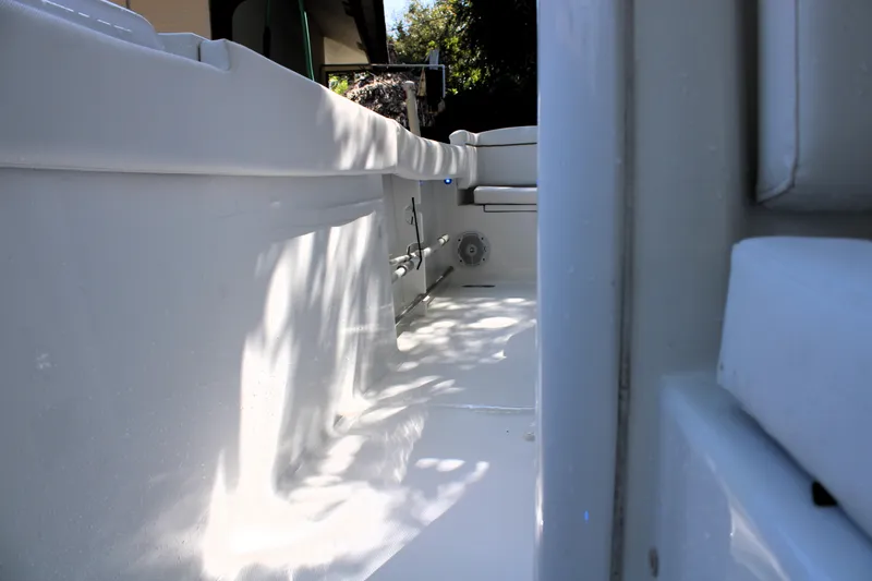 Slide: The Image of 2018 Sea Hunt Ultra 255 SE boat interior, showcasing sleek white design and seating area. - 35