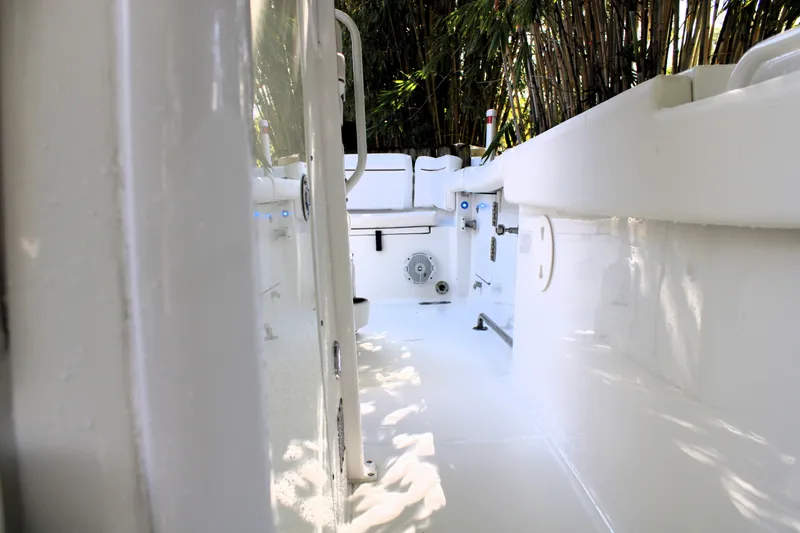 Slide: The Image of 2018 Sea Hunt Ultra 255 SE boat interior, sleek white design, spacious layout. - 36