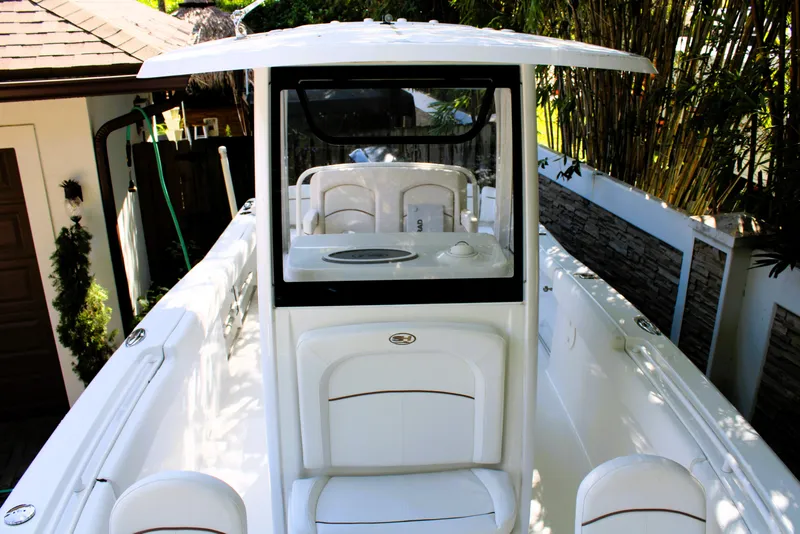 Slide: The Image of 2018 Sea Hunt Ultra 255 SE boat interior with seating and console. - 38