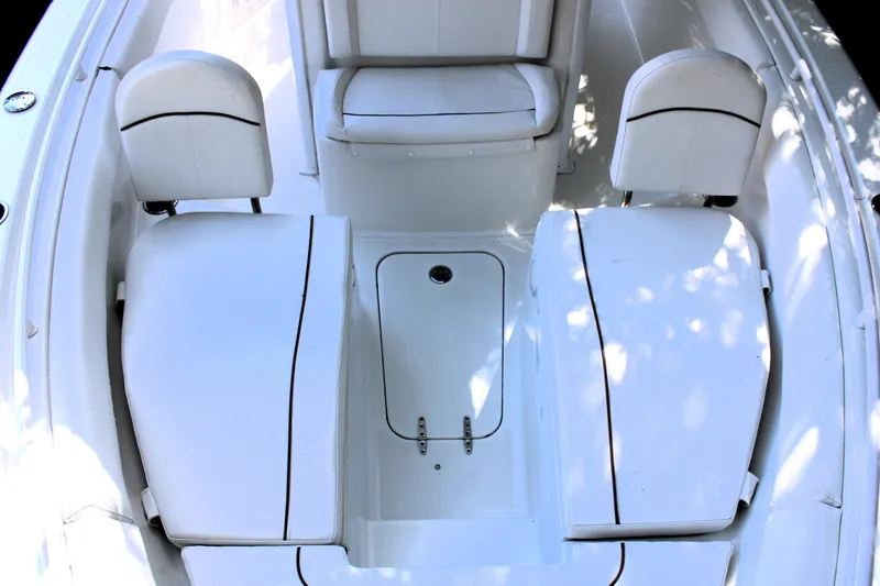 Slide: The Image of 2018 Sea Hunt Ultra 255 SE boat interior with white seating and storage compartments. - 39