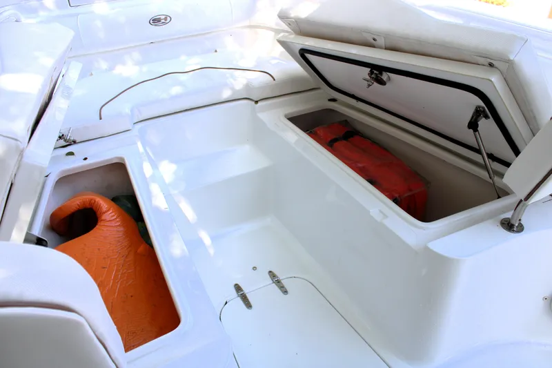 Slide: The Image of 2018 Sea Hunt Ultra 255 SE boat storage compartments with life jackets and equipment. - 41