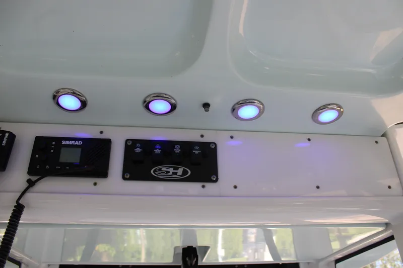 Slide: The Image of Control panel of 2018 Sea Hunt Ultra 255 SE boat with blue LED lights. - 46