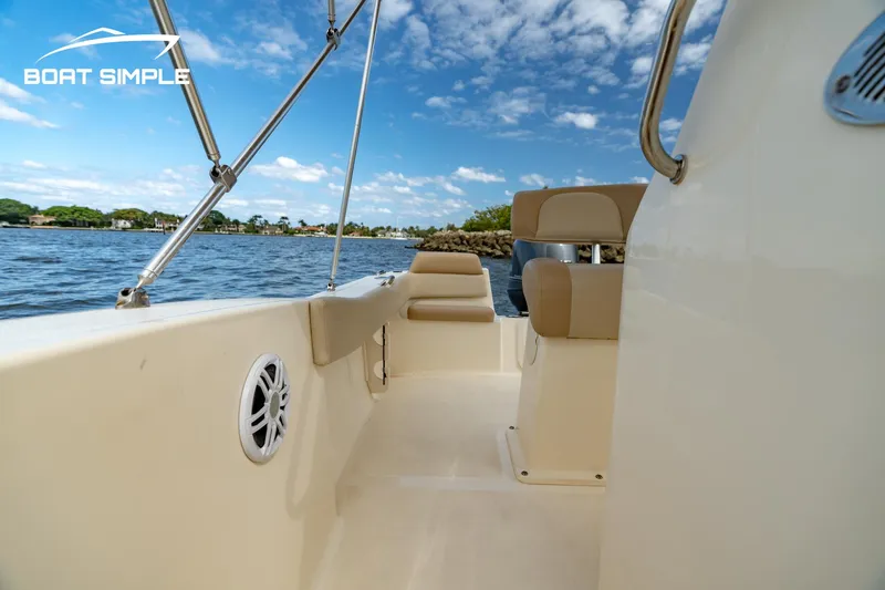 Slide: The Image of 2021 Scout 195 Sportfish boat interior with seating, on a sunny day. - 11