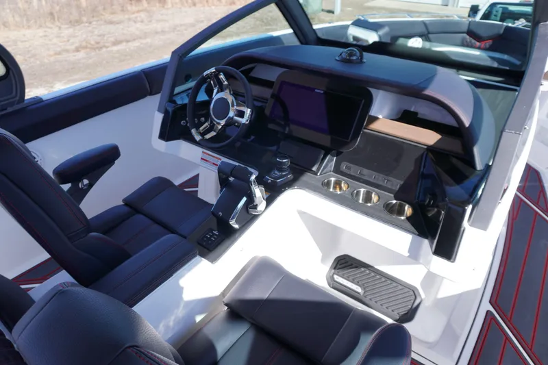 Slide: The Image of 2025 Monterey Elite 30 OB boat cockpit with modern steering and control panel. - 14