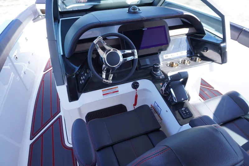 Slide: The Image of Cockpit of 2025 Monterey Elite 30 OB boat with modern steering and dashboard. - 15