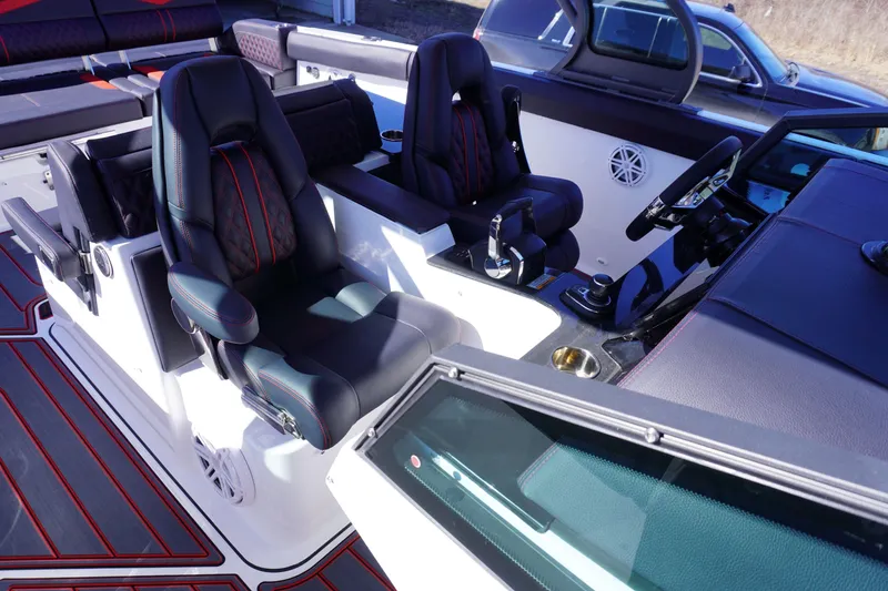 Slide: The Image of Interior of 2025 Monterey Elite 30 OB boat with luxurious seating and modern dashboard. - 16