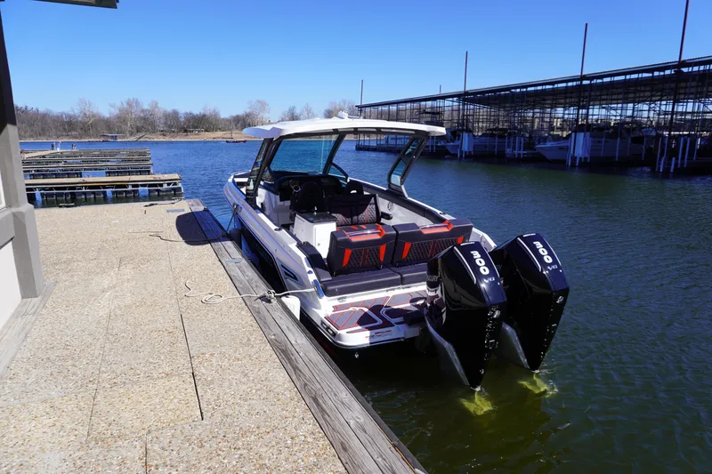 Slide: The Image of 2025 Monterey Elite 30 OB boat docked with dual outboard engines. - 3