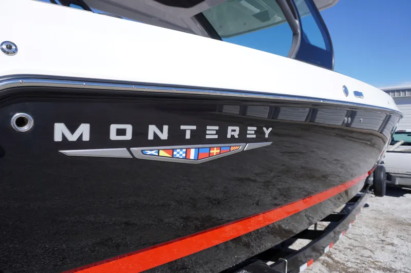 Slide: The Image of 2025 Monterey Elite 30 OB boat with sleek black and red design. - 7