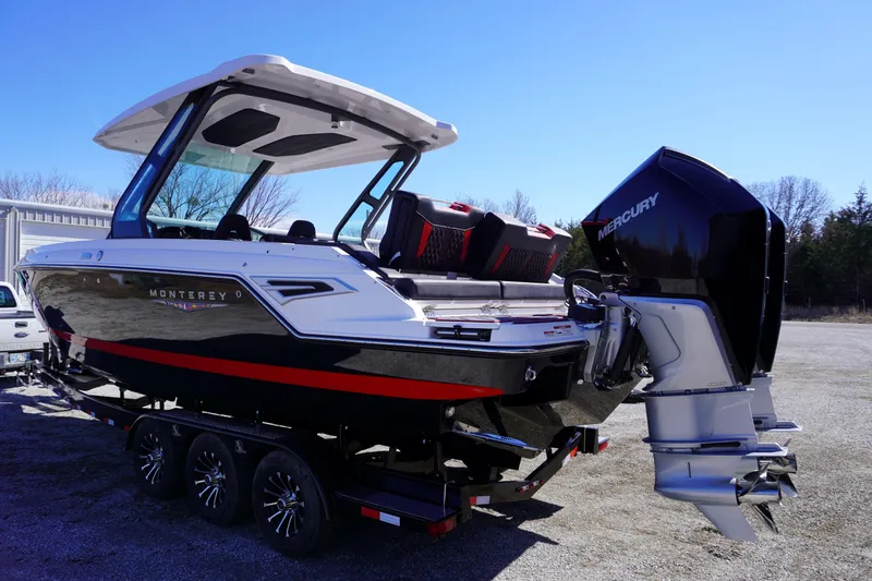 Slide: The Image of 2025 Monterey Elite 30 OB boat with Mercury outboard engine on a trailer. - 8