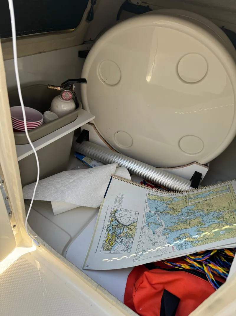Slide: The Image of 2008 Sea Ray 230 Sundeck interior with map, sink, and storage items. - 15