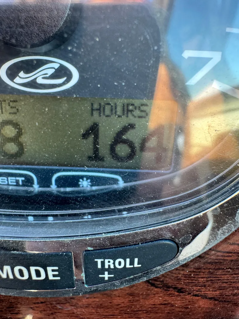 Slide: The Image of Close-up of 2008 Sea Ray 230 Sundeck hour meter displaying 164 hours. - 16
