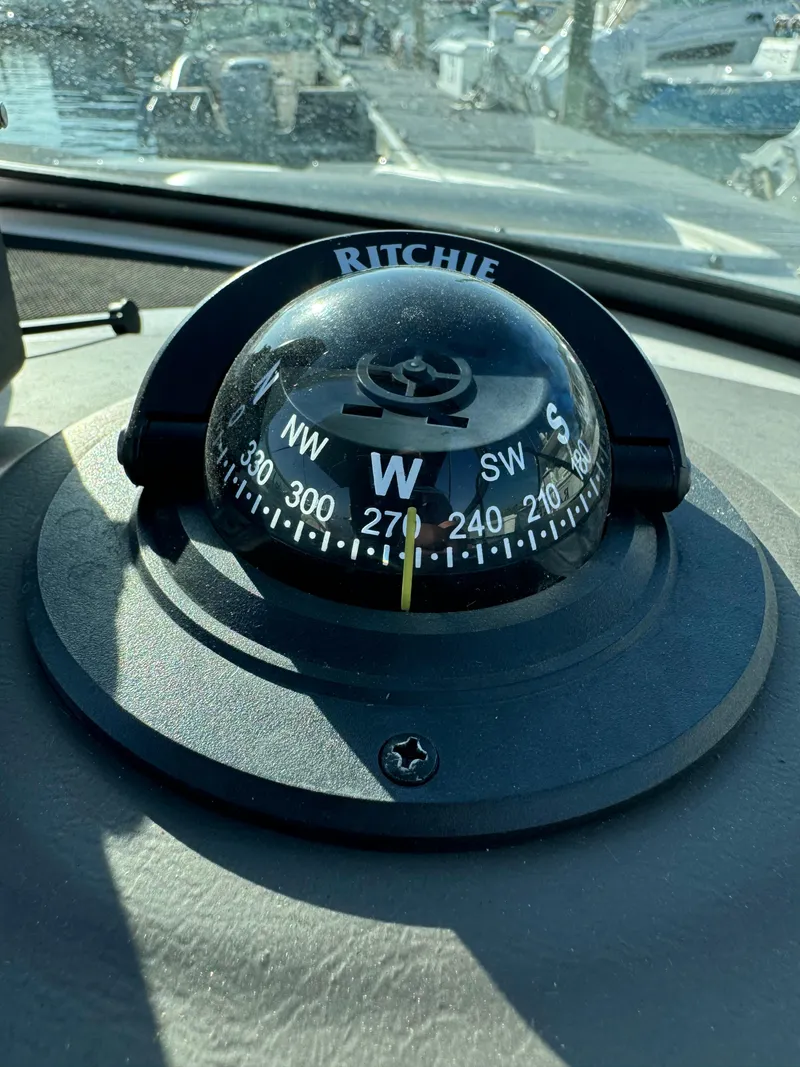 Slide: The Image of Ritchie compass on 2008 Sea Ray 230 Sundeck boat dashboard. - 19