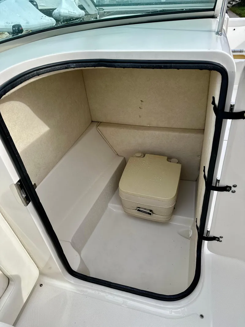 Slide: The Image of 2008 Sea Ray 230 Sundeck interior storage compartment with portable toilet. - 20