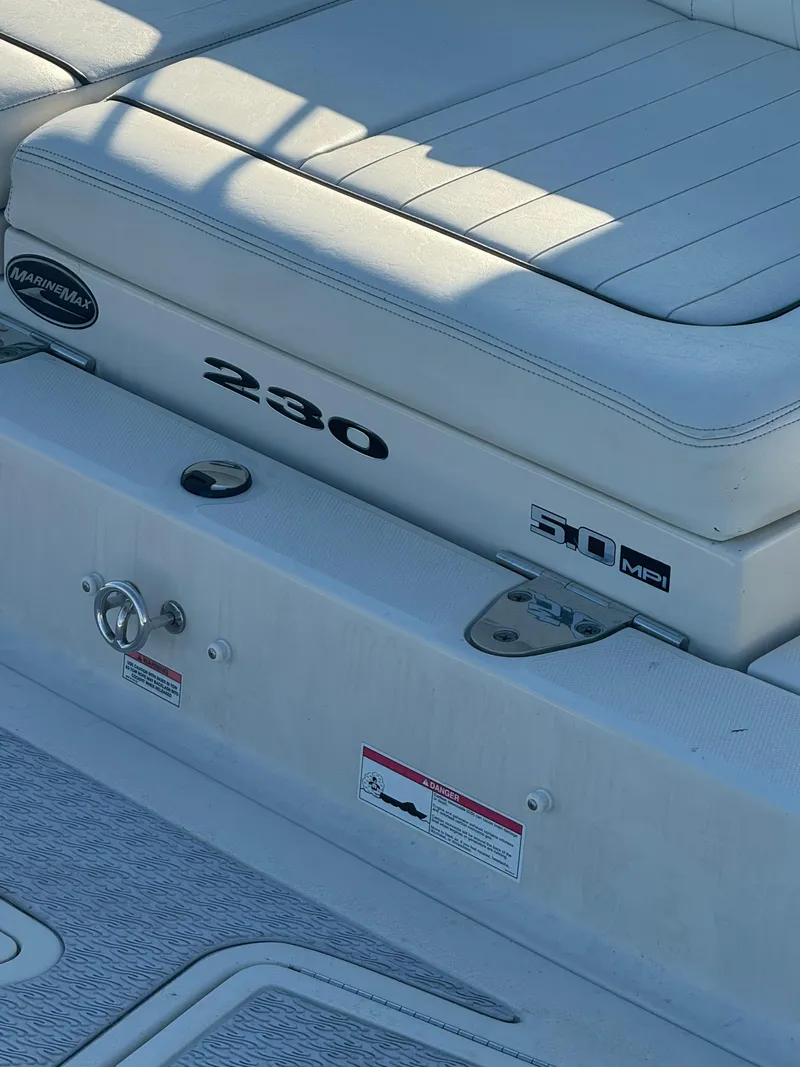 Slide: The Image of 2008 Sea Ray 230 Sundeck boat seating area with model branding. - 5