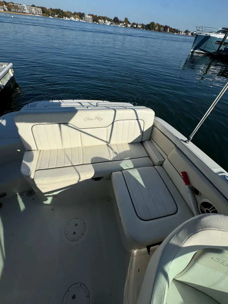 Slide: The Image of 2008 Sea Ray 230 Sundeck boat interior with seating, on a calm lake. - 8