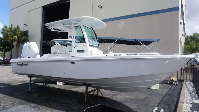 Slide: The Image of 2025 Everglades 253 CC boat displayed outdoors near a building. - 1