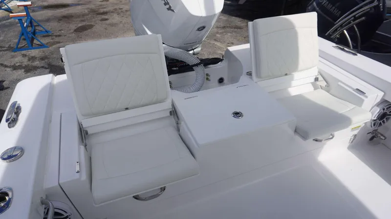 Slide: The Image of 2025 Everglades 253 CC boat with white cushioned seating and outboard motor. - 11
