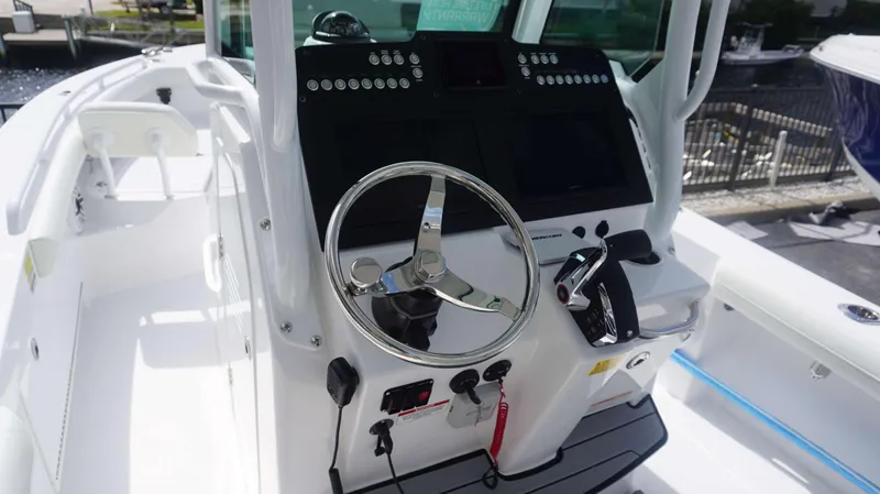 Slide: The Image of 2025 Everglades 253 CC boat cockpit with steering wheel and control panel. - 16