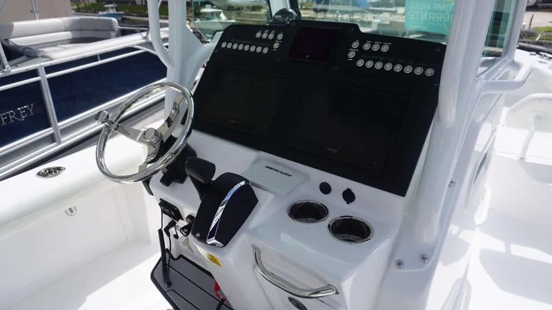 Slide: The Image of 2025 Everglades 253 CC boat console with steering wheel and control panel. - 17
