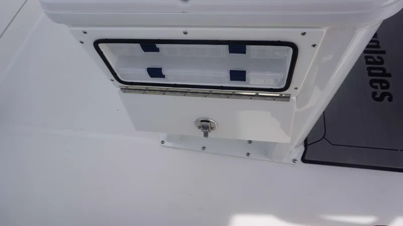Slide: The Image of Everglades 253 CC 2025 boat storage compartment with secure latch. - 21
