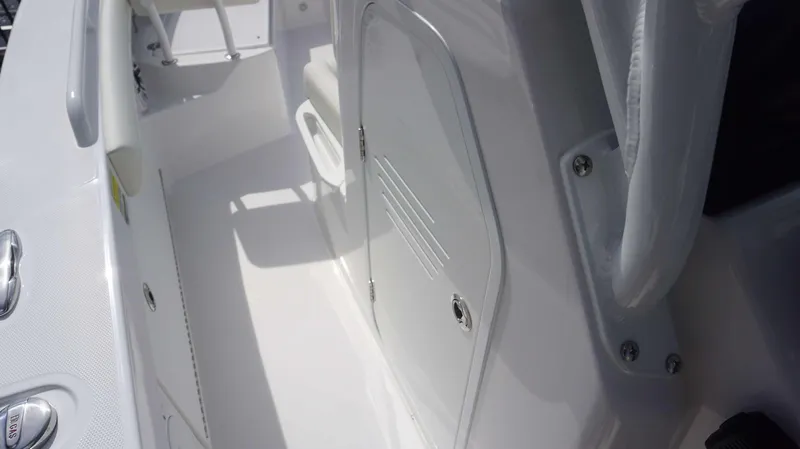 Slide: The Image of 2025 Everglades 253 CC boat interior with white seating and storage compartment. - 24