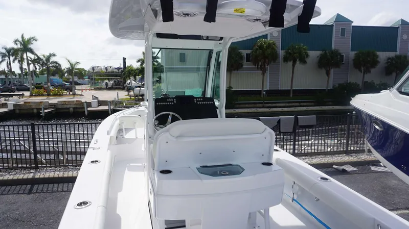 Slide: The Image of 2025 Everglades 253 CC boat docked, featuring sleek design and modern amenities. - 4