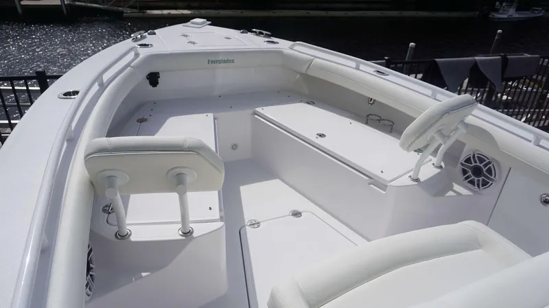 Slide: The Image of 2025 Everglades 253 CC boat interior with white seating and storage compartments. - 5