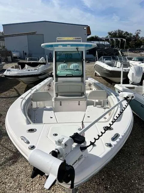 Slide: The Image of 2022 Everglades 273 CC boat with white deck, parked in a marina. - 3