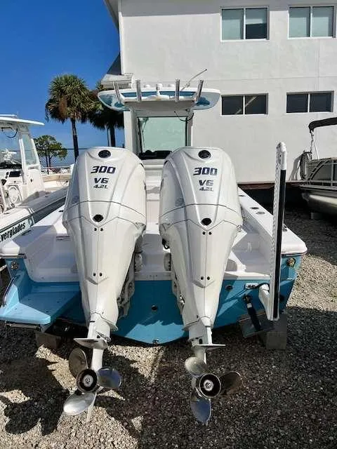 Slide: The Image of 2022 Everglades 273 CC boat with twin 300 V6 engines, docked outdoors. - 4