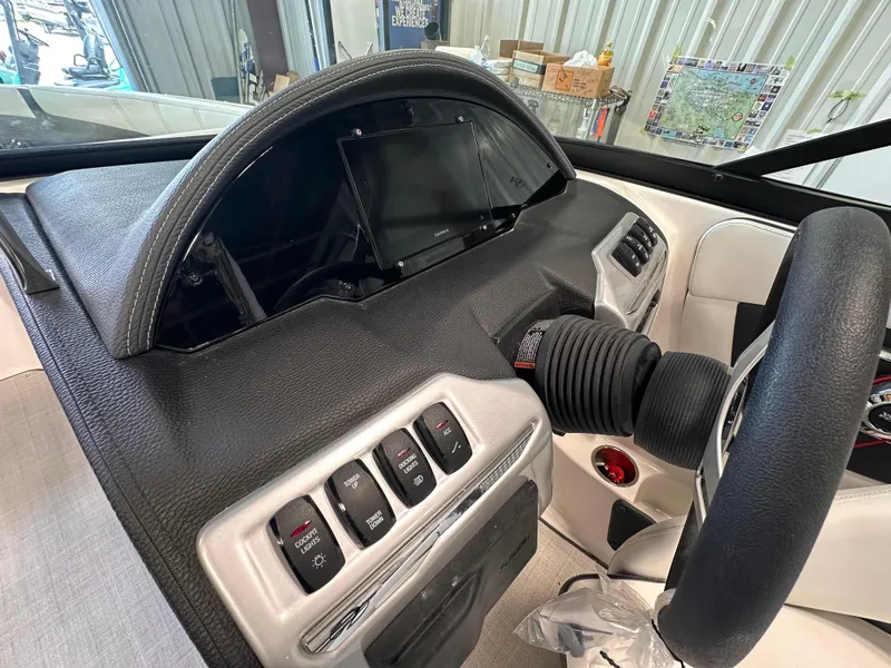 Slide: The Image of 2025 Regal 2000 ES boat dashboard with modern controls and steering wheel. - 13