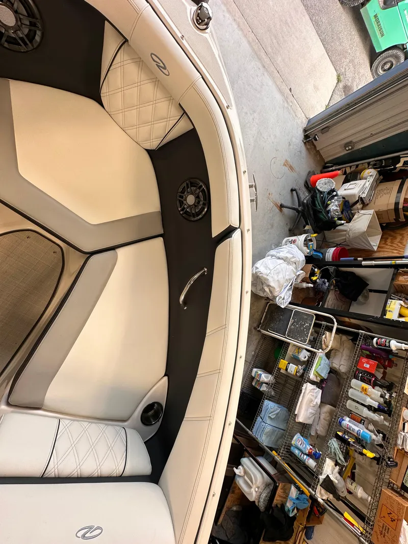 Slide: The Image of 2025 Regal 2000 ES boat interior in garage with equipment. - 16