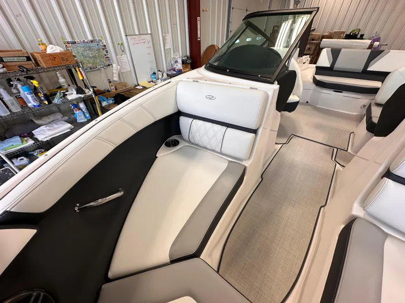 Slide: The Image of 2025 Regal 2000 ES boat interior with white and black seating in a workshop setting. - 17