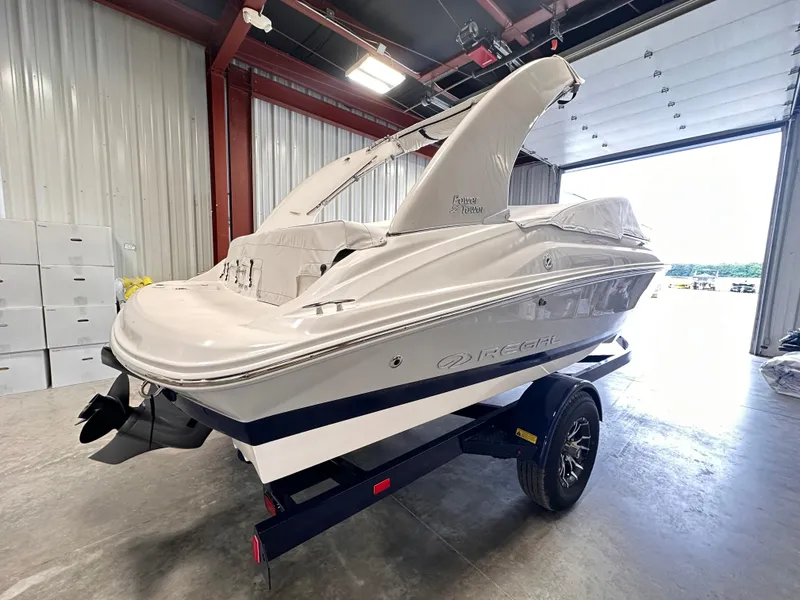 Slide: The Image of 2025 Regal 2000 ES boat on trailer in a garage setting. - 4