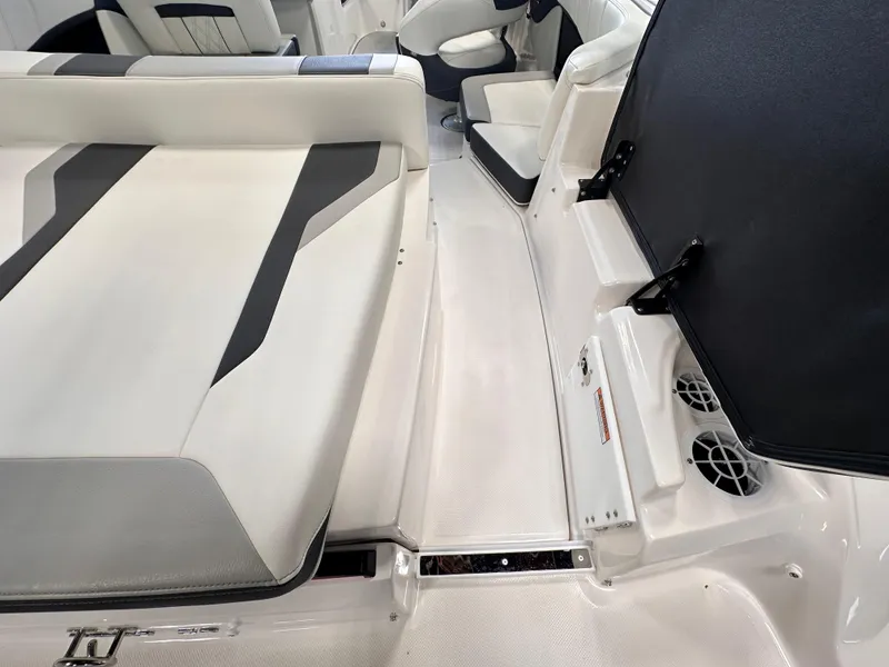 Slide: The Image of 2025 Regal 2000 ES boat interior with white and gray seating, modern design. - 8
