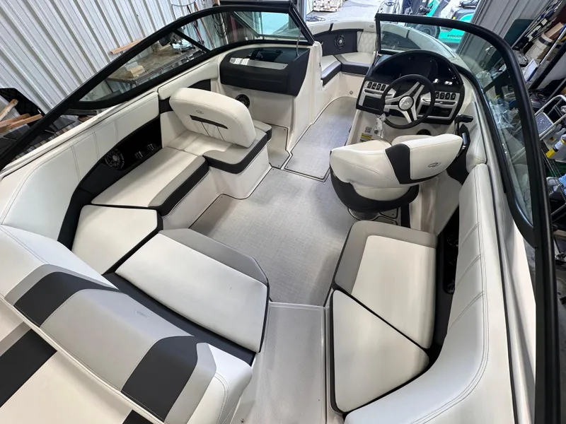 Slide: The Image of 2025 Regal 2000 ES boat interior with sleek white and black seating, modern dashboard. - 9