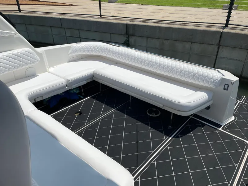 Slide: The Image of Luxurious seating on 1998 Sea Ray 400 Sundancer yacht, featuring white upholstery and sleek design. - 3
